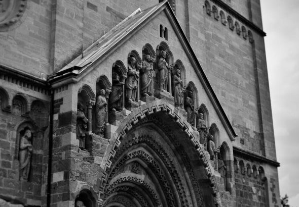 Vintage-style photograph capturing the intricate details of Ják Church's façade in Hungary.